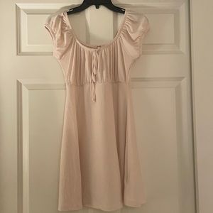 cream scooped neck dress with bow in front